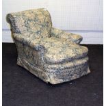 A Howard Bridgewater style deep seated armchair with scroll back and floral covers