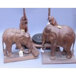 A large vintage carved teak wood figure of an elephant moving timber, together with an elephant