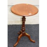 A Victorian walnut tripod table, the circular top on a baluster and ring turned column, and