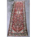 A 20th century Bahktiari runner, with red ground and fish motif, 82 x 298cm