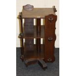 An early 20th century Arts and Crafts style oak revolving bookcase with pegged silhouette stiles