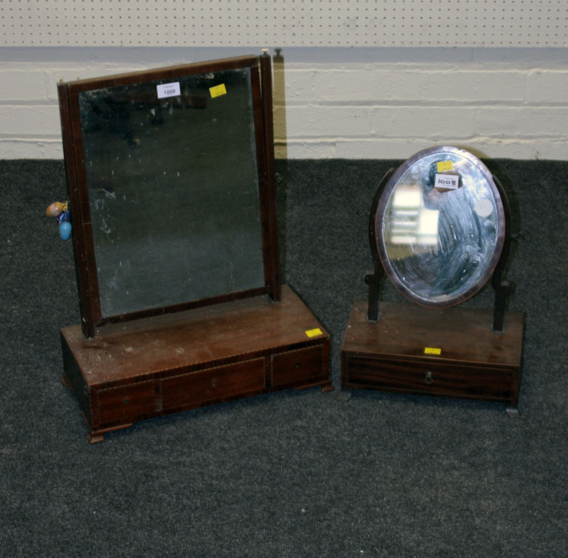 A George III inlaid mahogany swing mirror, fitted three drawers to the base, raised on shaped