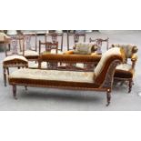 A Victorian walnut nine piece salon suite with carved decoration, comprising nail back chaise