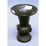 A 19th century Japanese bronze vase, having a flared rim, knopped and ridged body decorated with