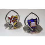 A pair of Edwardian menu holders, octagonal bases with shield shaped enamel plaques being coat of