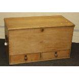 A Victorian pine coffer, the plank top over twin steel handles and two base drawers with turned knop