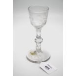 An 18th century rounded bucket bowled ale glass, with facet cut knop stem and dog rose etched