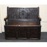 A 19th century carved oak box settle, the three panel back with Star of David decoration,125cm wide