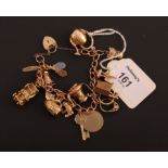 A gold charm bracelet, the 9ct open curb pattern bracelet suspending numerous charms, including a