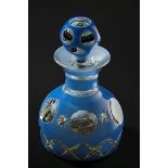 A large blue to clear glass overlay scent bottle, the stopper and body set with cut cane