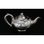 An early Victorian silver teapot, melon form, the body chased with scrolls and foliage, monogram and