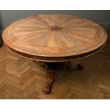 A William IV flame mahogany breakfast table, the deep crossbanded circular tilt top with segmented