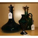 A mid 19th century green glass spirit decanter with brass mounts and loop handle, together with a