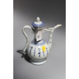 A Chinese blue and white porcelain ewer and cover, painted with a monk working at a scroll with