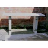 An Italian mottled cream travertine console table, the rectangular top with scroll ends on twin