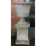 A pair of large impressive established reconstituted stone garden urns and plinths, with moulded