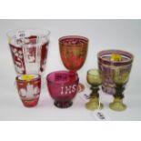 A 20th century Bohemian ruby flashed and etched glass beaker with lumpen base and panels of etched
