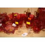 A collection of Victorian cranberry glass, including a near pair of dimpled spirit decanters, a pair