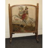 A Victorian oak country house firescreen, set with a gros point tapestry panel of a Turk on