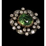 A late Victorian gem-set diamond brooch, the central cushion-shaped green stone within a foliate
