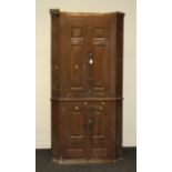 A George III painted pine two section freestanding corner cupboard