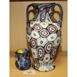 An Italian millefiori glass twin handled baluster vase with mauve and white cut cane decoration,