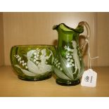 A 19th century Mary Gregory green glass jug with clear loop handle, enamel decorated with a young