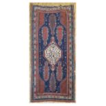 An early 20th century Caucasian Shakli rug, with distinctive arrow design, with multiple borders,