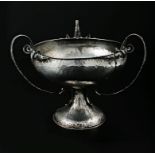 An Art Nouveau silver comport, the three handled spot hammered circular bowl on spreading circular