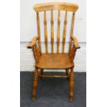 A Victorian beech and elm spindle back open armchair, with saddled seat, on baluster turned legs,