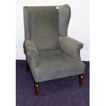 A George III style gentleman's wing back fireside chair with green stuffover upholstery and