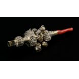 A Victorian silver gilt and coral whistle-cum-rattle, the lobed body chased with leaves, with