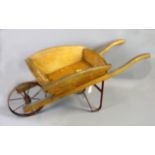 A vintage Swallows Toys oak children's wheelbarrow with wrought iron fittings