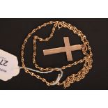 An Edwardian 9ct gold cross and chain, the foliate engraved cross with associated chain