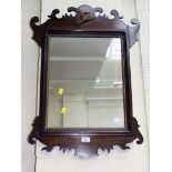 A George II style mahogany fret frame wall mirror with applied phoenix, gilt egg and dart moulded