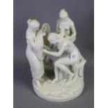 An early 20th century white glazed porcelain figure group of The Three Graces, on a circular base