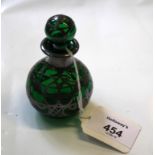 A Victorian green glass scent bottle with spherical stopper and silver strap work overlay, 9cm