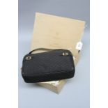 A black Gucci handbag in box