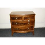 An early 19th century mahogany satinwood crossbanded and boxwood strung chest, of bow fronted form