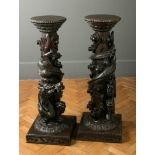 A pair of late Victorian elm torchere, each having a beaded circular top above a column richly