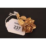 An 18ct gold spray brooch, in the form of a rose and bud, 16g