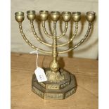 A gilt brass menorah candle holder, with stepped acanthus decorated base, 23cm wide