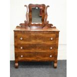 A 19th century American cherry wood and mahogany 'dresser', with three long drawers and a shaped