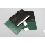A Lanvin black crocodile wallet and three green wallets