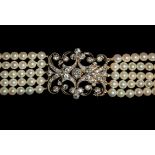 A cultured pearl and diamond choker, the large open work rectangular plaque de cou decorated with