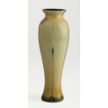 An early Twentieth century Loetz style cased glass vase of a slender tapering baluster form, pale