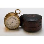 An Edwardian brass leather cased travelling barometer with compass verso. 5cm diameter