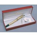 A Mont Blanc gilt metal cased ballpoint pen with ribbed barrel and cap, in a Sheaffer box