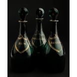 A set of three late 18th century green glass spirit decanters, each with flattened stopper, chain