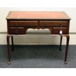 An Edwardian mahogany lady's writing desk, the rectangular top fitted with a gilt tooled red hide